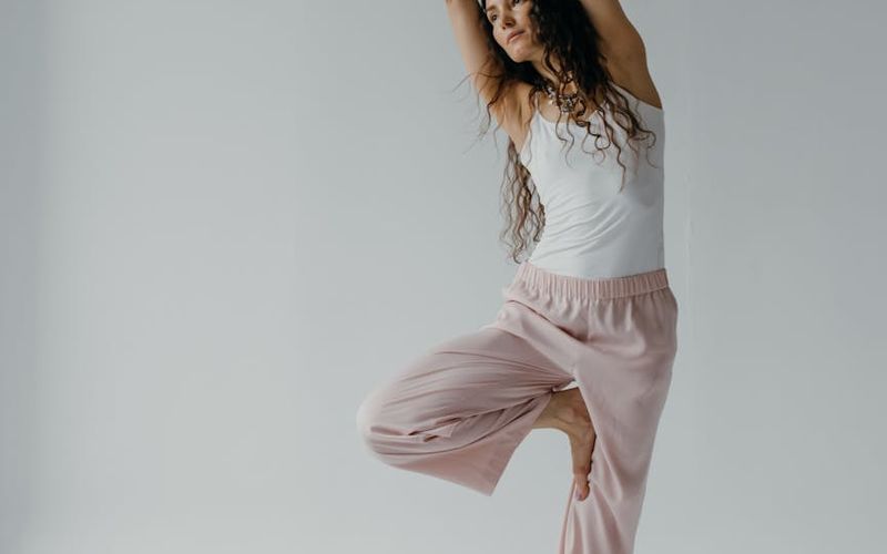 A person performing a sequence of flowing yoga movements in a calm studio.